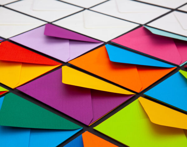 Composition with white and colored envelopes on the table. The photo suitable for various holidays and anniversaries.